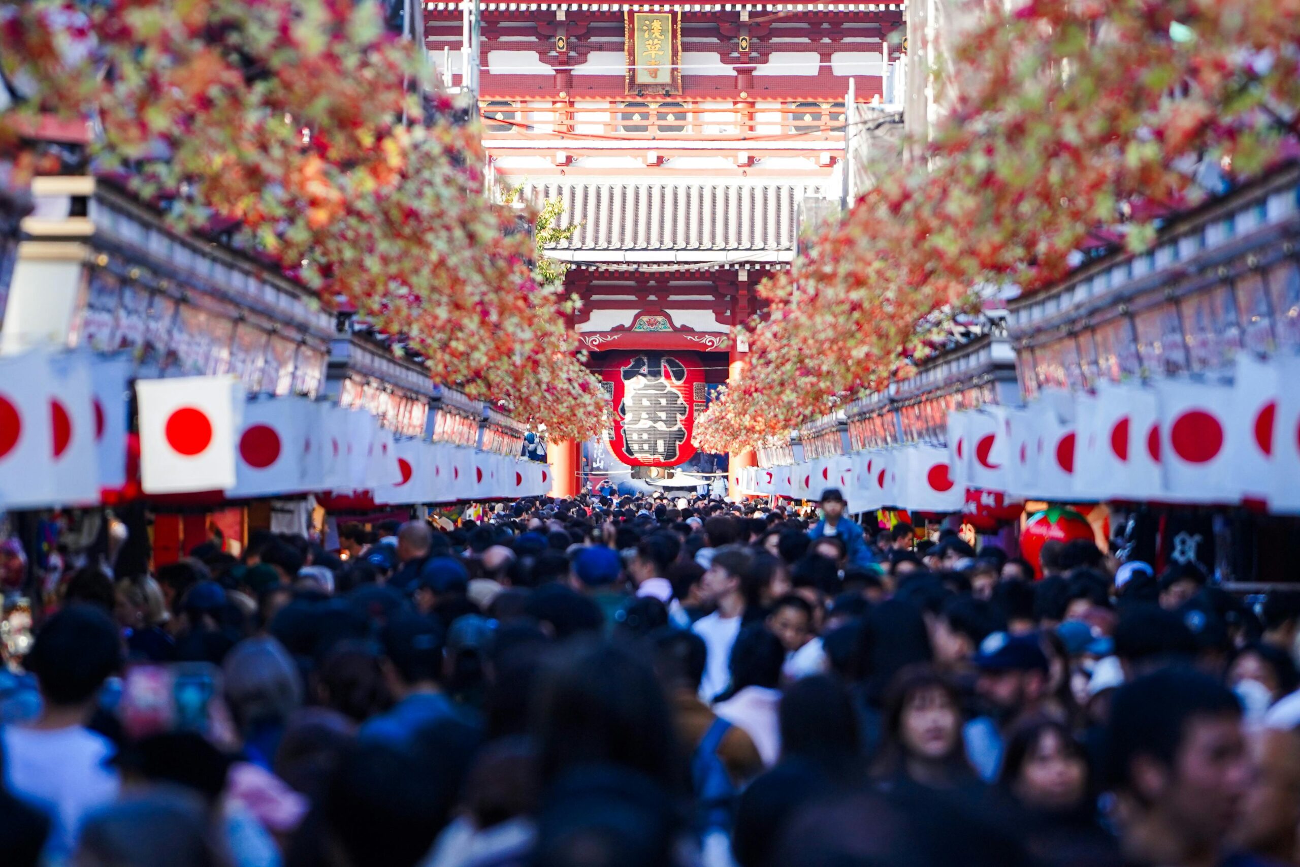 Vibrant crowd at Sensō-ji Temple in Asakusa, Tokyo, during a festive day.