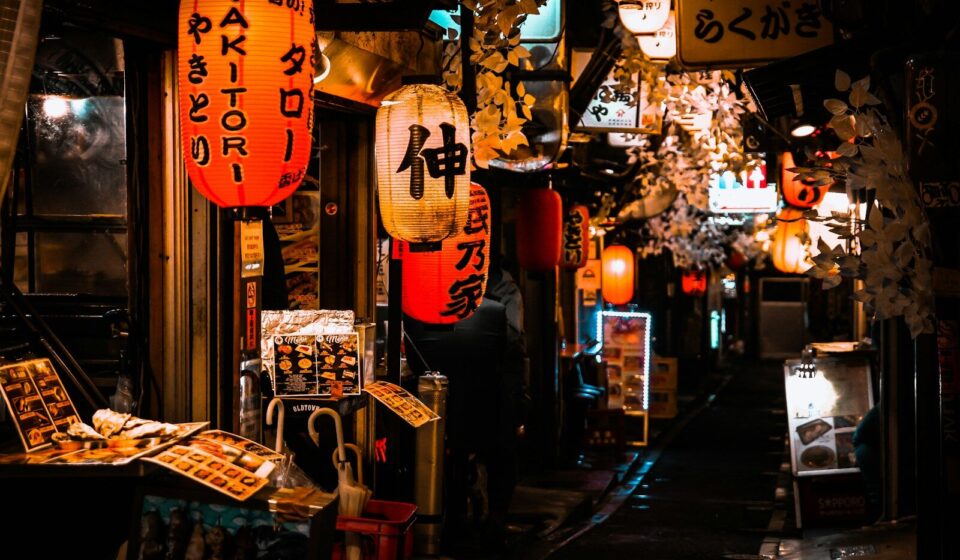 people walking on sidewalk during night time
